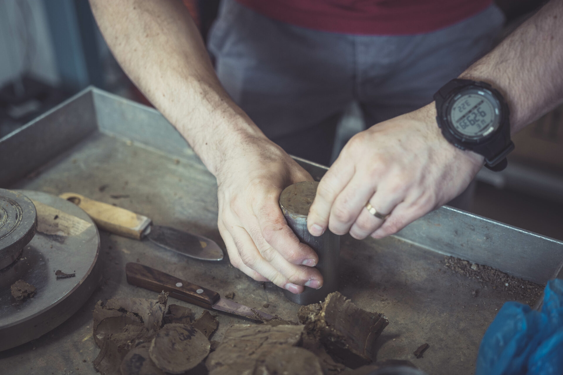 Geotechnical Engineer preparing a soil sample for a laboratory test to determine shear strength